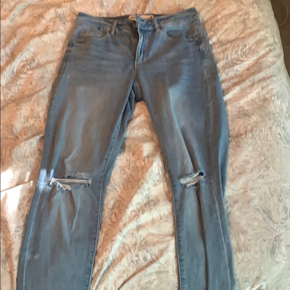 Light wash jeans with rips in the knees
